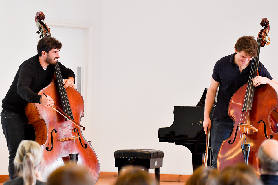 Two double bass players participating in a masterclass